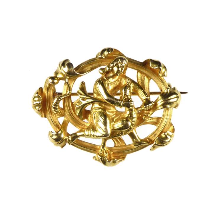 Gold revivalist scroll brooch with St George and the dragon